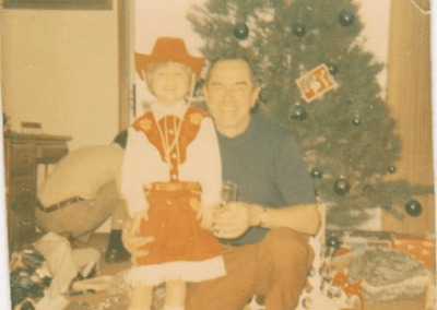 A photo of young Jessica Kelley and her grandfather - HPZ at Christmas. (Cowboy outfit, not so much!)